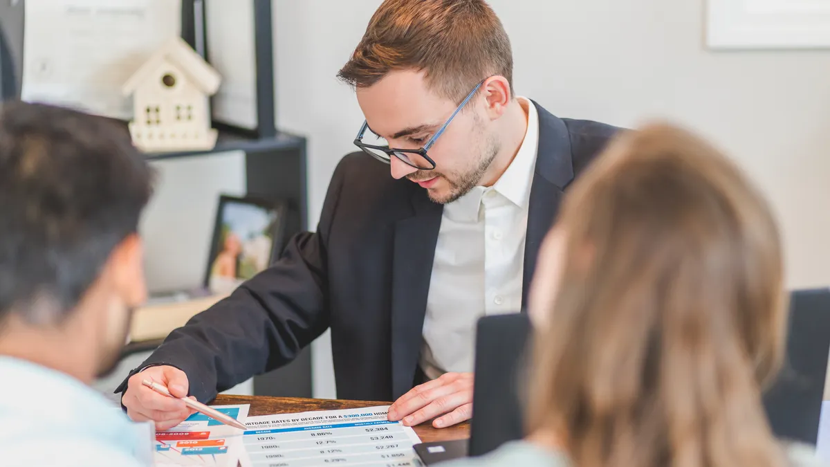 How to compare online lenders vs banks vs credit unions Loan consultation at a desk with clients